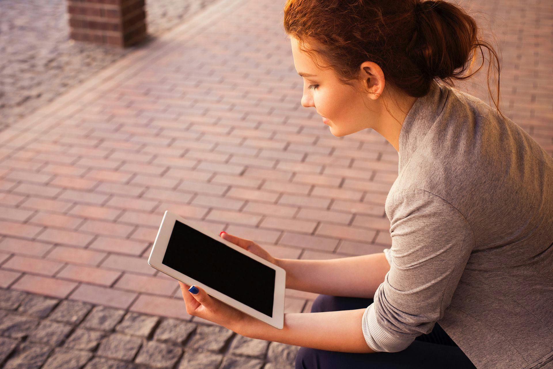 woman holding an ipad