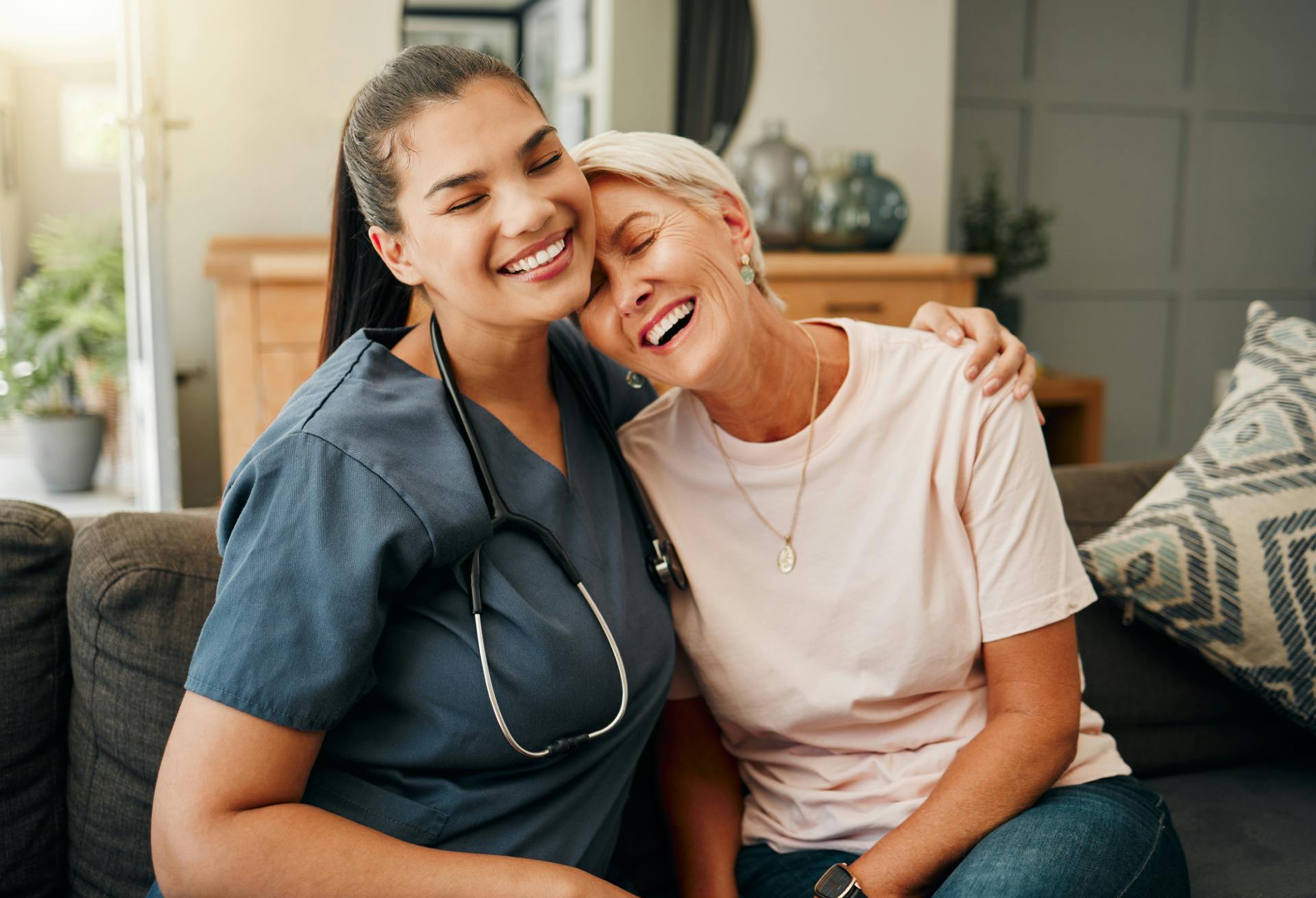 woman sitting on the couch hugging and smiling