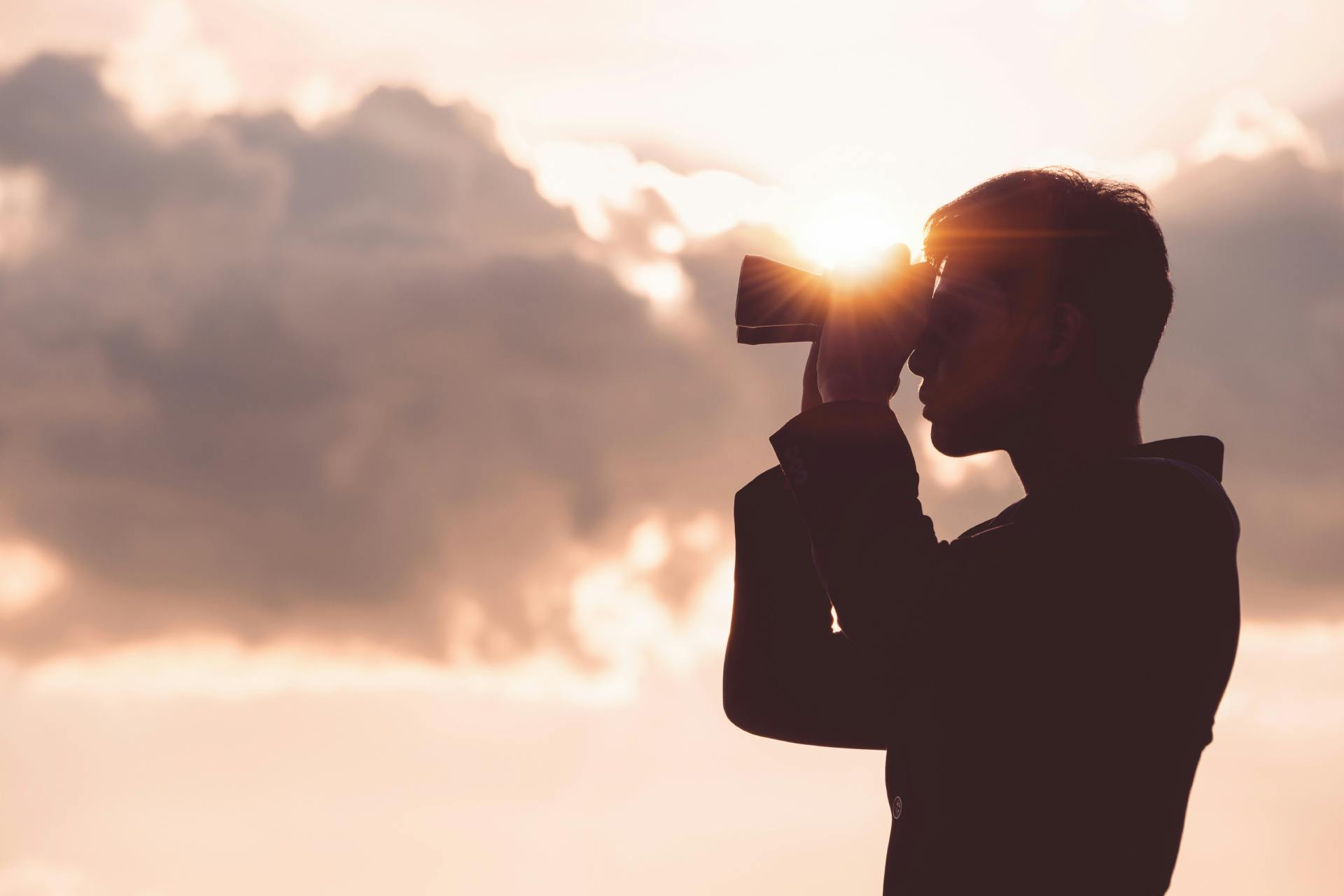 man looking out of binoculars