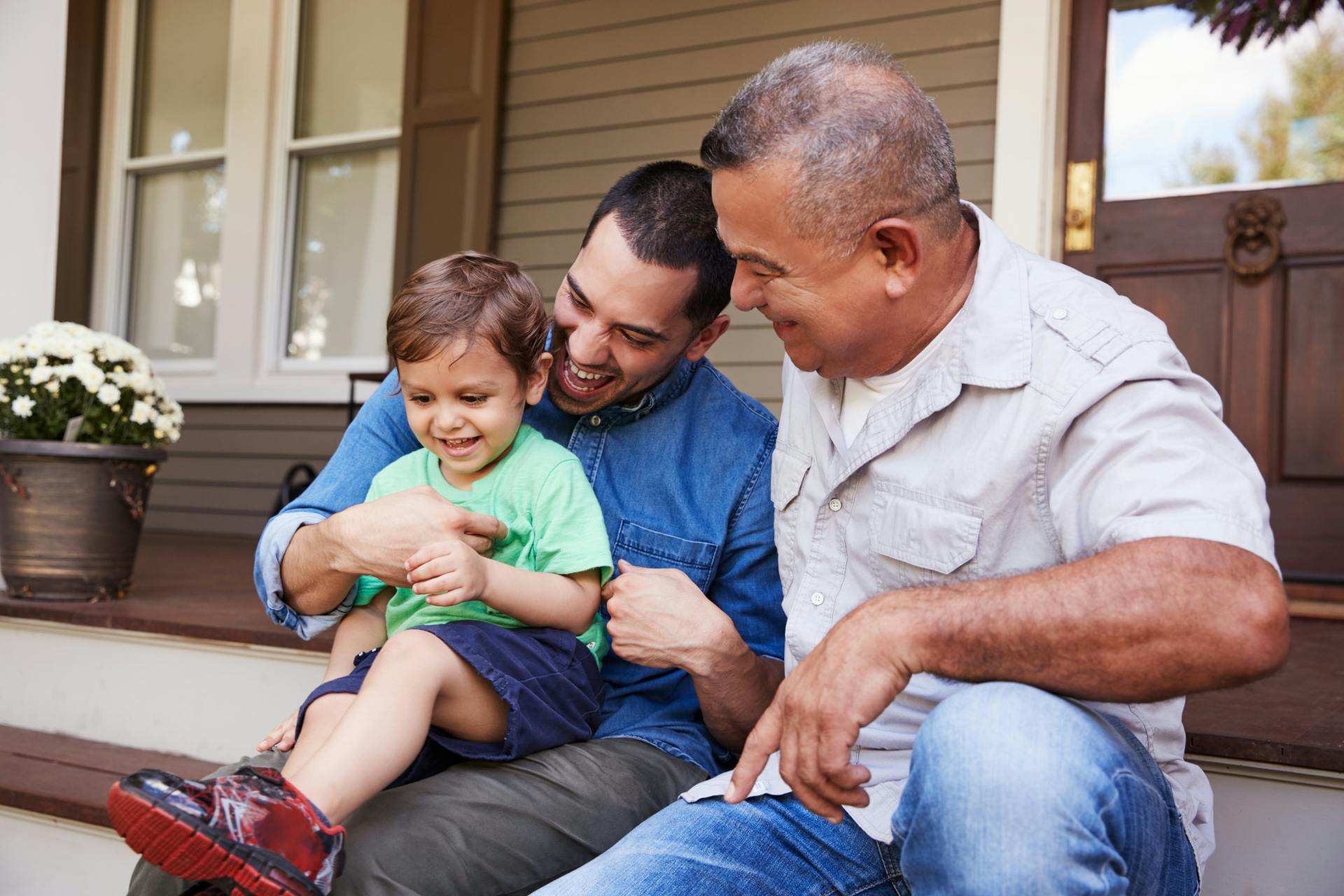 family sitting on the porch laughing