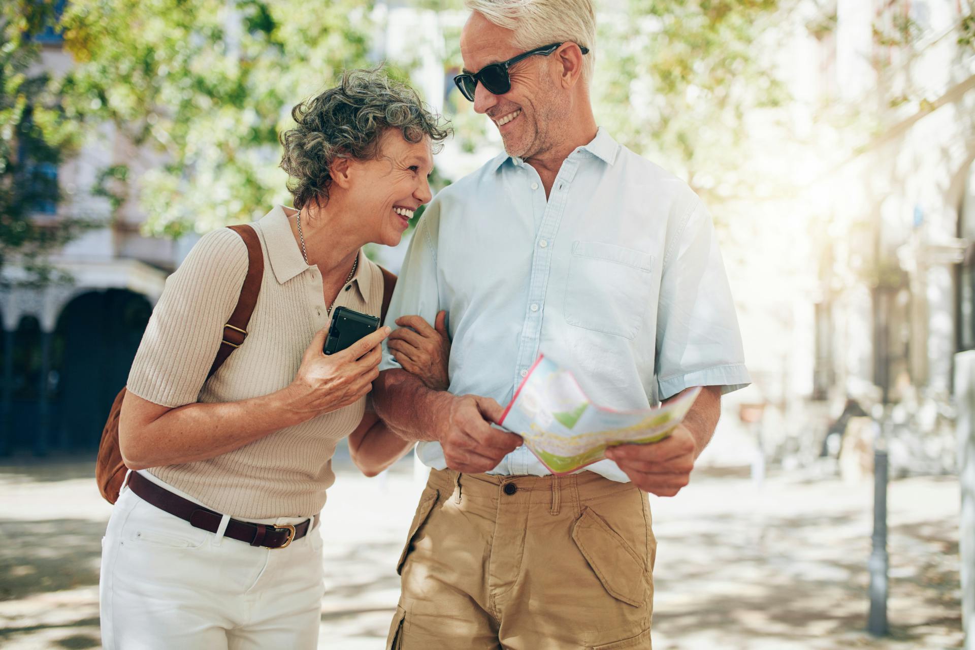 couple linking arms laughing together