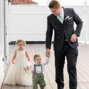 man holding baby boy hand walking