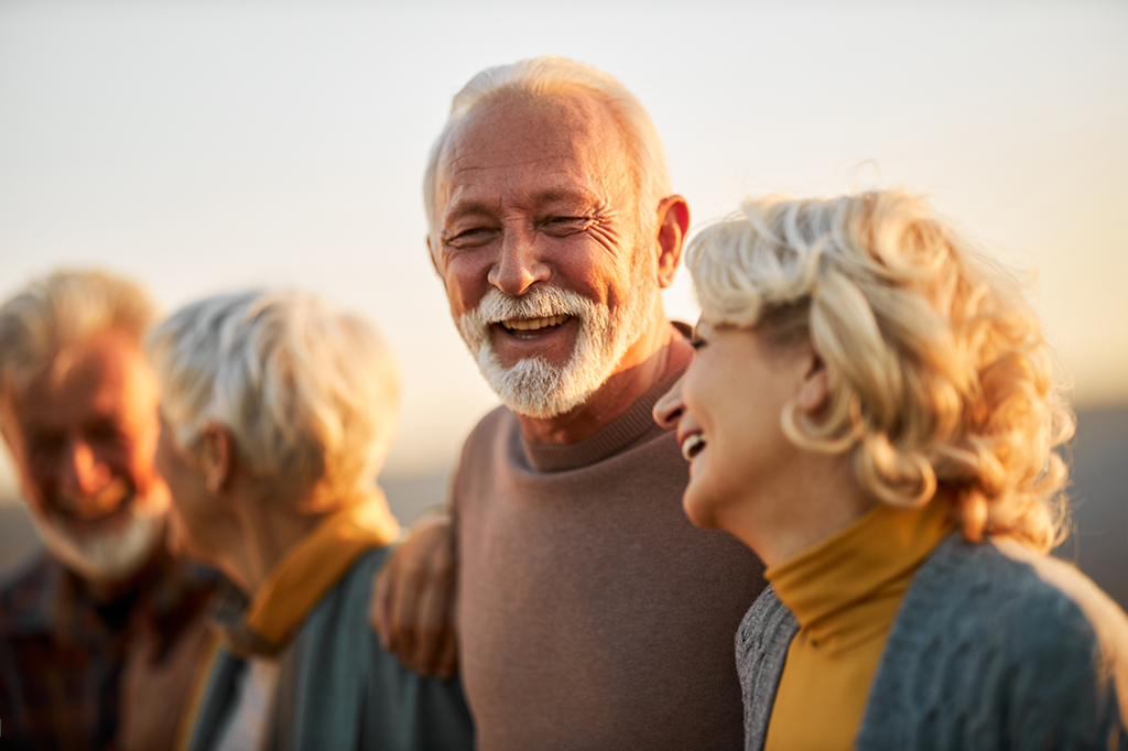 couple with their arms around each other laughing