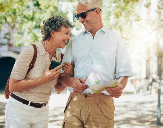 couple linking arms laughing together